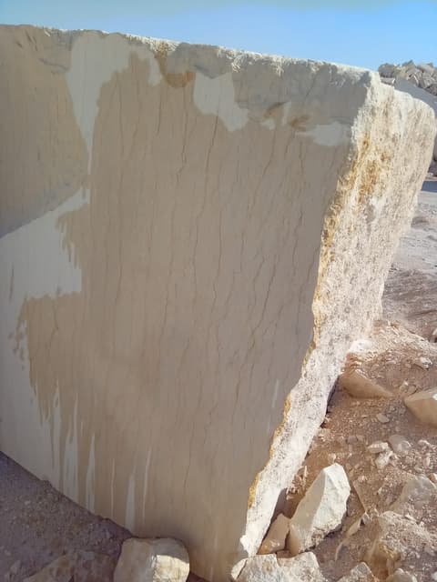 Large sawn Minya marble block at the quarry, cut face showing fine vertical veining