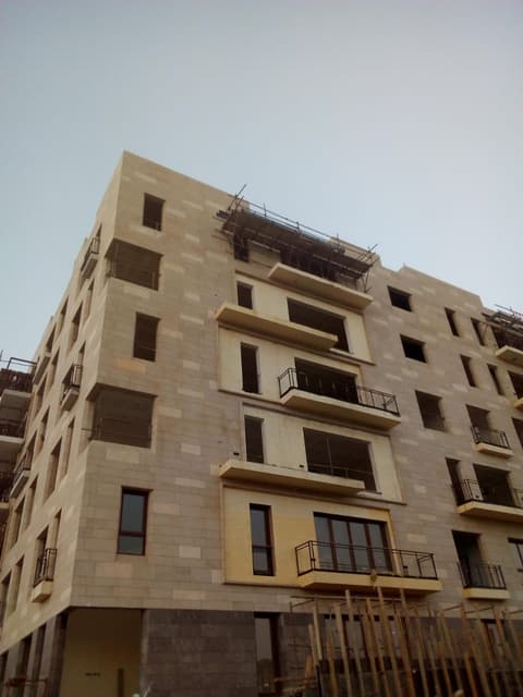 Apartment building facade clad in Egyptian limestone